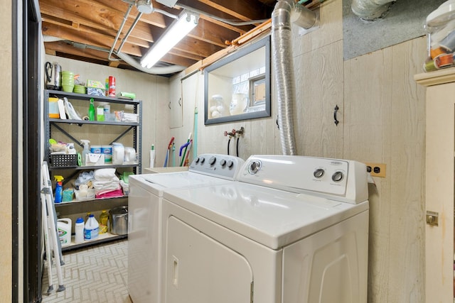 clothes washing area featuring laundry area and washer and clothes dryer