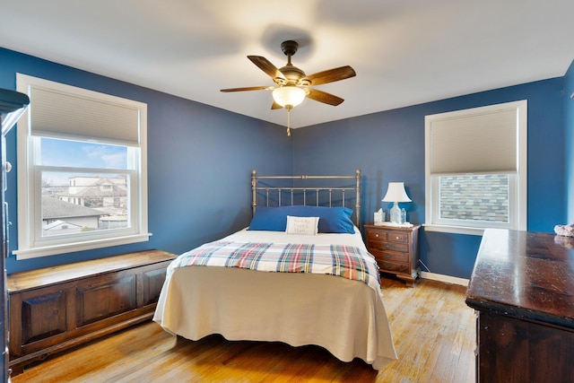 bedroom featuring light wood-type flooring, ceiling fan, and baseboards