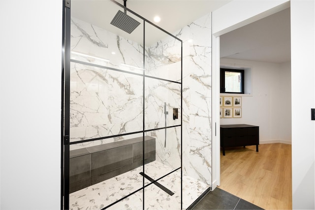 full bath with wood finished floors and a marble finish shower