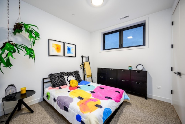 carpeted bedroom featuring visible vents and baseboards