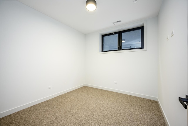 unfurnished room with visible vents, light carpet, and baseboards