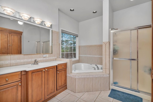 bathroom with vanity, a shower stall, a bath, and tile patterned floors