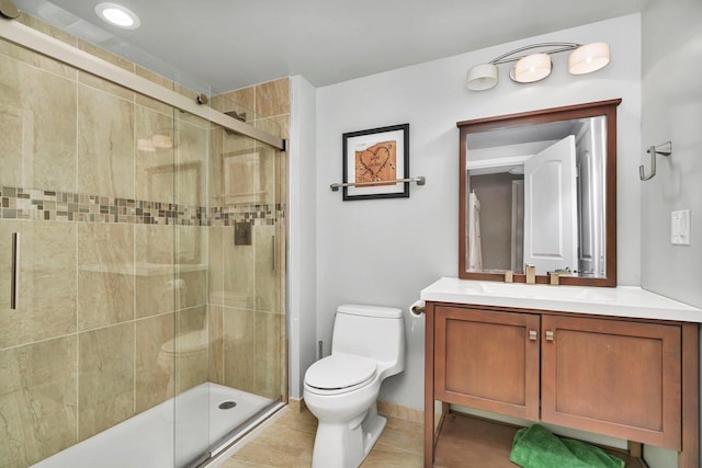 full bathroom featuring toilet, a stall shower, tile patterned flooring, and vanity