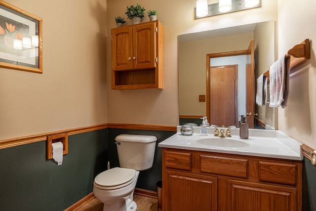 half bathroom featuring toilet and vanity