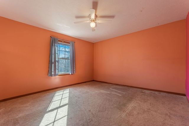 unfurnished room featuring carpet floors and baseboards