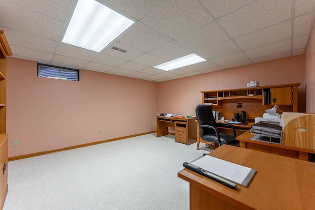 carpeted office with visible vents, baseboards, and a drop ceiling