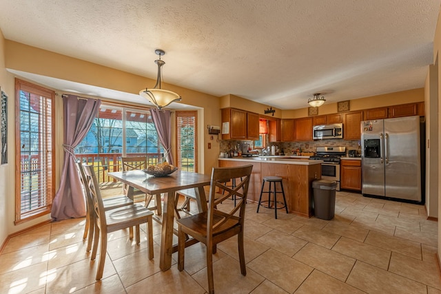 dining room featuring light tile patterned floors and a textured ceiling