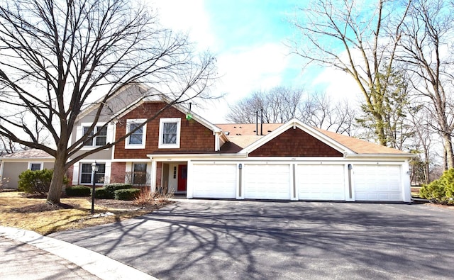 view of front of property featuring a garage and aphalt driveway