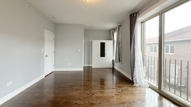 unfurnished room featuring wood finished floors and baseboards