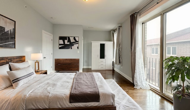 bedroom with wood finished floors and baseboards