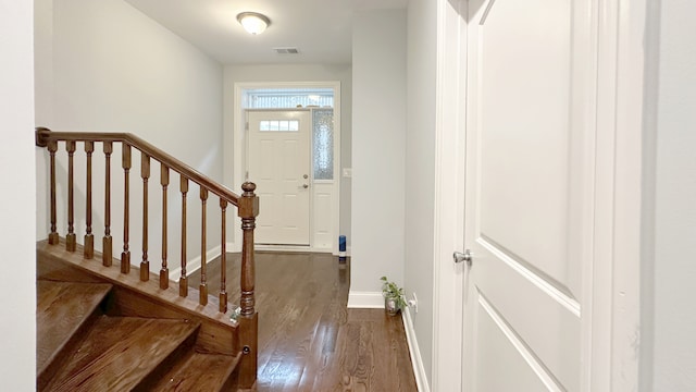 foyer featuring stairs, wood finished floors, visible vents, and baseboards