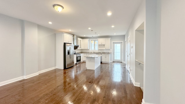 kitchen featuring appliances with stainless steel finishes, dark wood finished floors, white cabinetry, and recessed lighting