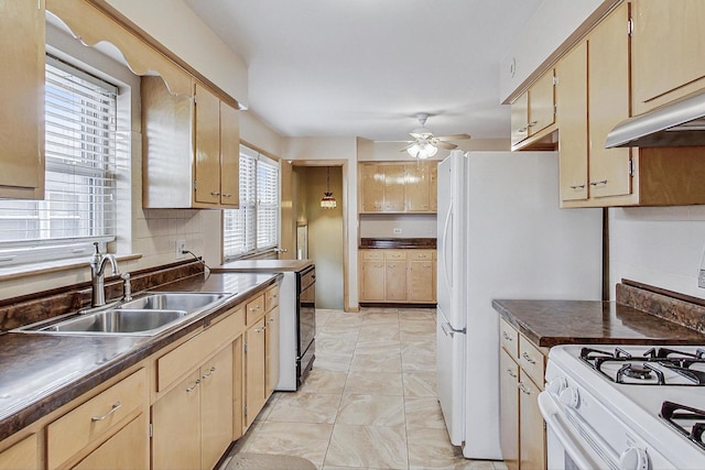 kitchen with a sink, a ceiling fan, electric stove, tasteful backsplash, and dark countertops