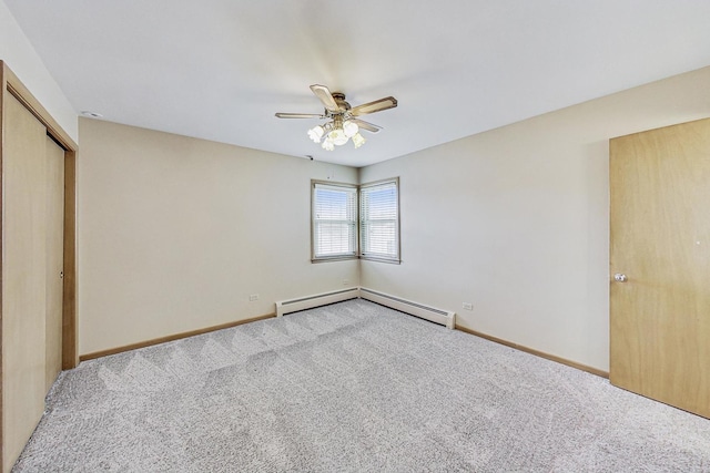 empty room with baseboards, carpet flooring, ceiling fan, and baseboard heating