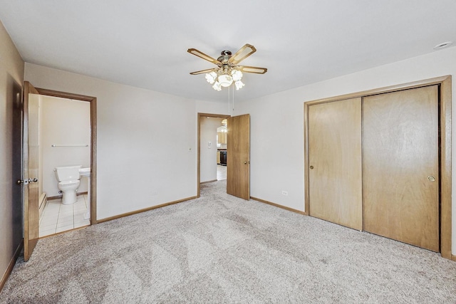 unfurnished bedroom featuring a closet, carpet flooring, connected bathroom, and baseboards