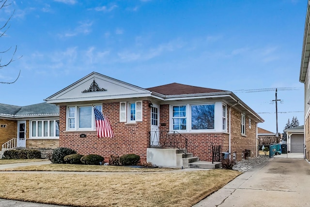 bungalow-style house with an outbuilding and brick siding