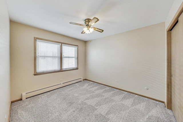 carpeted empty room featuring a ceiling fan, baseboards, and baseboard heating