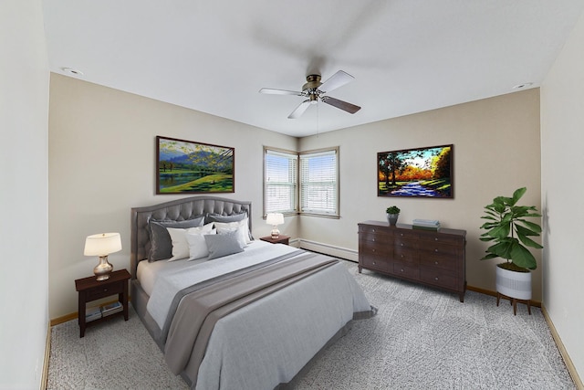 bedroom with baseboards, a baseboard heating unit, a ceiling fan, and light colored carpet