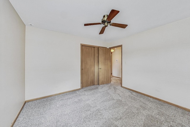 unfurnished bedroom featuring light carpet, a closet, and baseboards