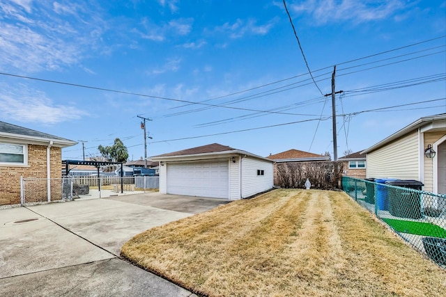 exterior space with an outbuilding, a fenced backyard, and a detached garage