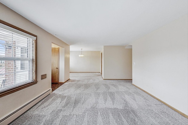 unfurnished room with light carpet, a baseboard radiator, a notable chandelier, and baseboards