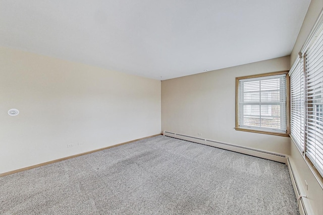 carpeted empty room with a baseboard radiator and baseboards