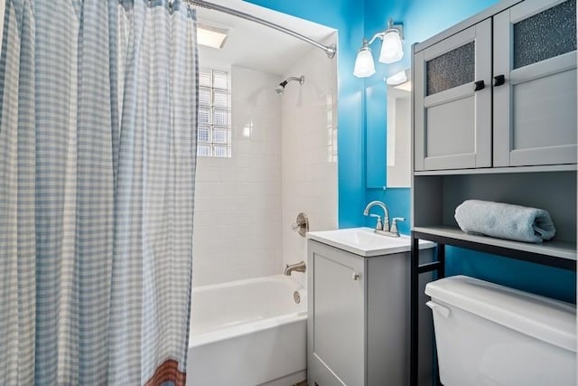 bathroom featuring shower / bath combination with curtain, vanity, and toilet