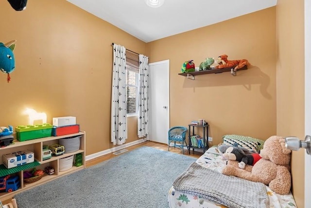 bedroom with visible vents, baseboards, and wood finished floors