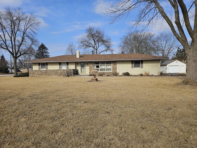 single story home with a garage, a front yard, an outdoor structure, and a chimney