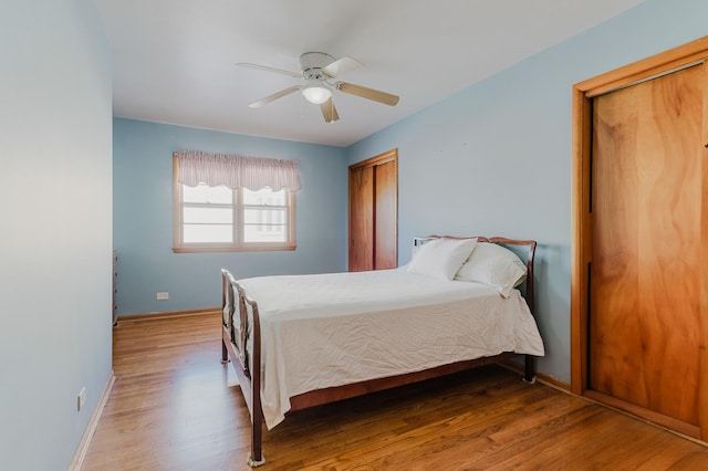 bedroom featuring wood finished floors, a ceiling fan, and baseboards