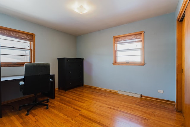 home office featuring baseboards and wood finished floors