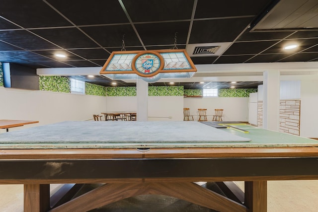 playroom with a paneled ceiling, visible vents, and a healthy amount of sunlight