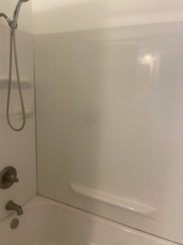 bathroom with bathing tub / shower combination