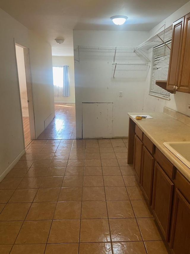 washroom featuring a sink and light tile patterned floors