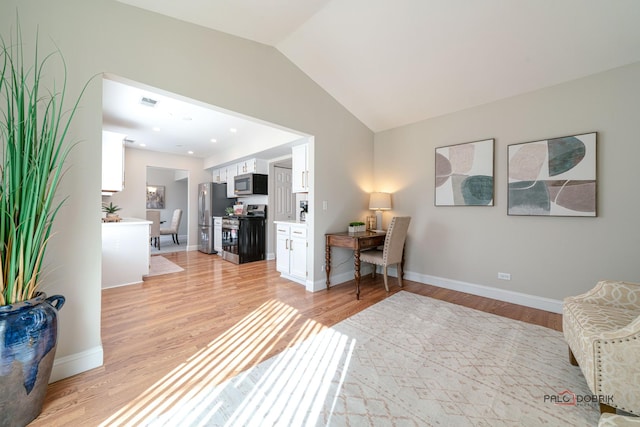 office with visible vents, baseboards, light wood-style flooring, vaulted ceiling, and recessed lighting