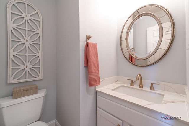 bathroom featuring toilet and vanity