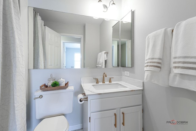 full bathroom with toilet and vanity