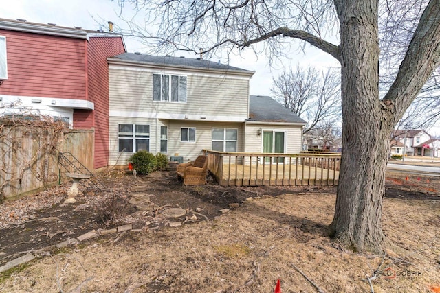 rear view of house featuring a wooden deck