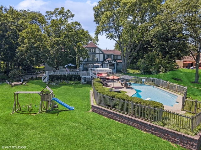 view of swimming pool featuring a patio area, a fenced backyard, a fenced in pool, and a lawn