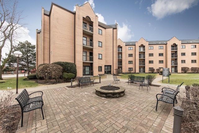 view of home's community featuring a fire pit and a patio