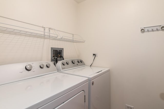 clothes washing area featuring laundry area and separate washer and dryer