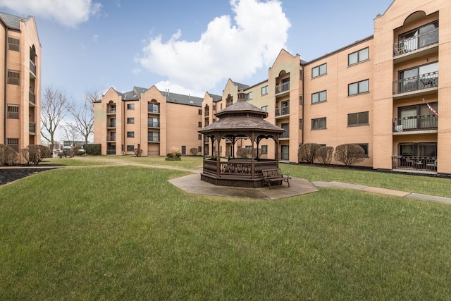 surrounding community with a lawn and a gazebo