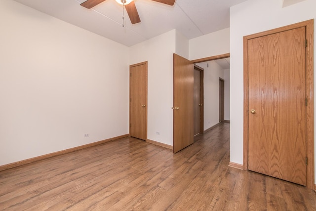 unfurnished bedroom featuring light wood-style floors, ceiling fan, and baseboards