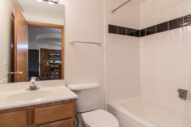 bathroom with shower / bath combination, vanity, and toilet