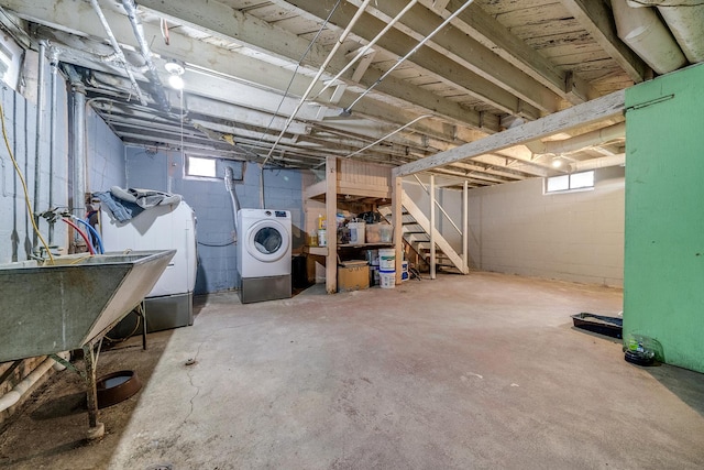 below grade area with stairs and separate washer and dryer