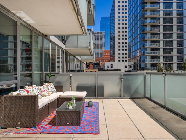balcony featuring a view of city and outdoor lounge area