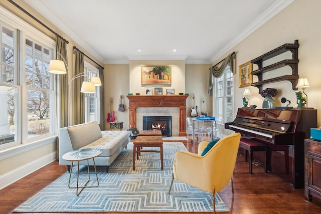 sitting room featuring ornamental molding, a fireplace, baseboards, and wood finished floors