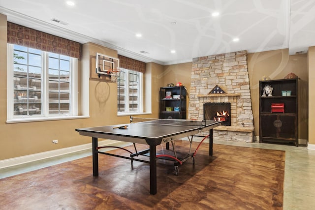 recreation room with finished concrete flooring, recessed lighting, a fireplace, and baseboards