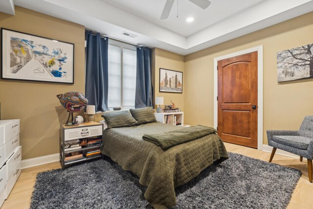 bedroom with light wood finished floors, baseboards, visible vents, and recessed lighting