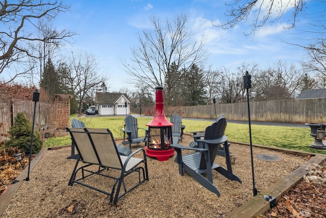 view of yard with a fenced backyard and a fire pit